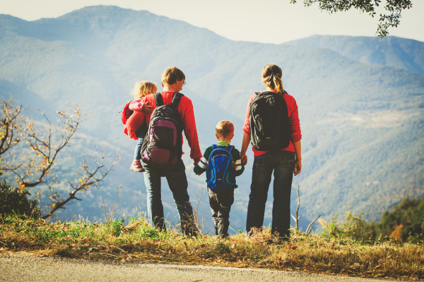 Family standing on mountain overlook enjoying the view